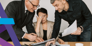 Worried manager struggling with paperwork, work related stress should be managed under an organisations Health & Safety policies and practices.