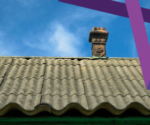 Image of a house roof against a blue sky. The roof is tiled with asbestos tiles, and there is a red stone chimney.